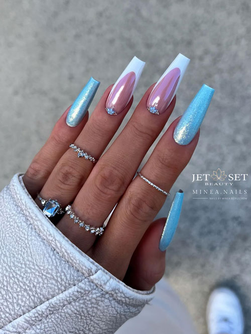 Glitter light blue coffin nails with two accent white French tip nails adorned with tiny light blue flower and rhinestones