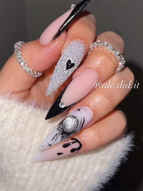 Classy Halloween nail design featuring silver glitter cobwebs, a spider, two black accents, and a nude nail with black drips.