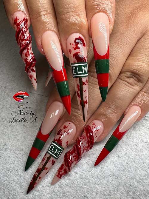 Long stiletto Freddy Krueger French nails featuring spooky bloody accent nails for a hauntingly stylish look.