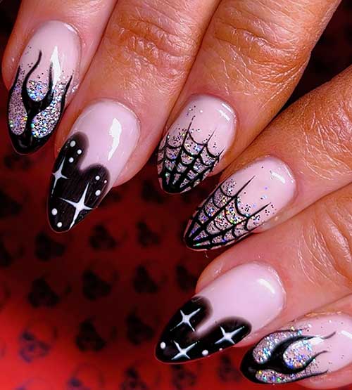 Short black Halloween nails with spider web designs, holographic glitter, flame accents, and witch-themed elements.