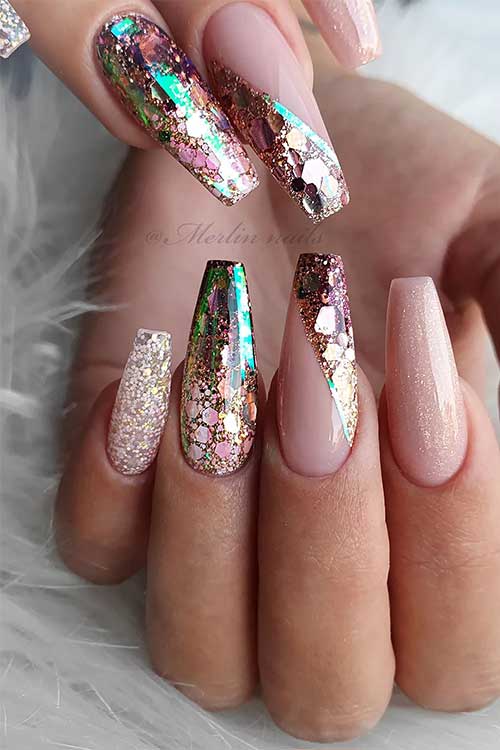 Festive nude coffin nails adorned with gold accents and vibrant tropical glitter for a stylish look.