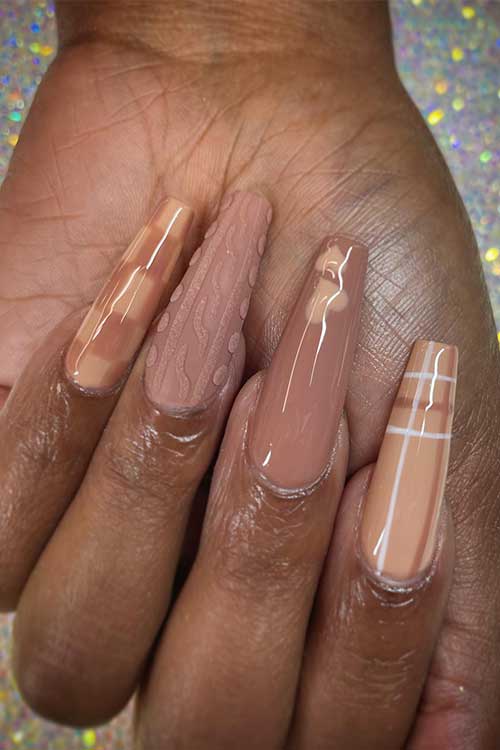 Long nude coffin nails featuring plaid, sweater, heart, and checkered designs in various nude shades for a stylish look.