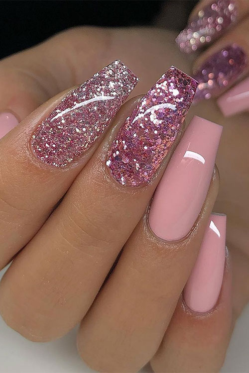 Long nude pink coffin nails with design feature two accents of rose gold glitter nails
