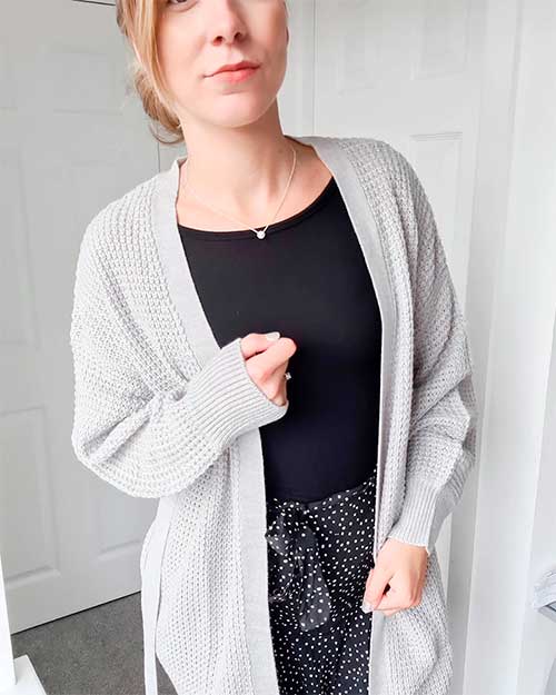 A gray cardigan put on a black top and a polka dot skirt create the perfect fall 2020 look in amazing fall colors!