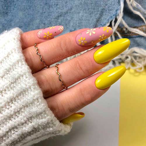 Almond shaped yellow nails with floral nail art on nude color nails for spring 2021!