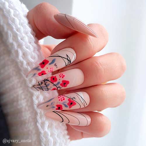 Cute almond-shaped nude color nails with red floral nail art blended with delicate black lines!