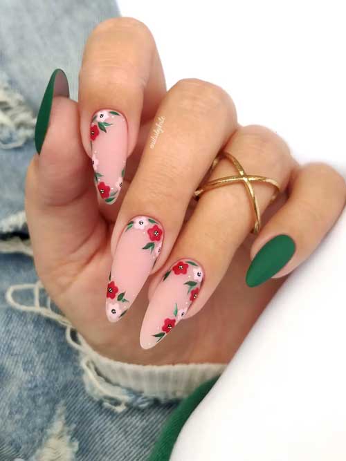 Long almond matte dark green nails with flowers on nude pink accent nails for spring season