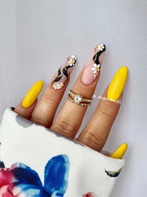 Long Almond-Shaped Yellow Nails with Daisy Flowers and Black Swirls on Two Accent Nude Nails
