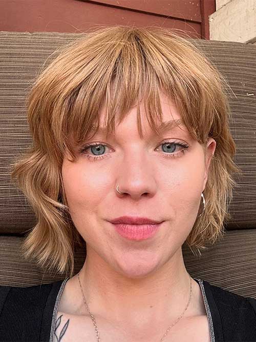 Textured shaggy bob hairstyle featuring a blunt cut, showcasing a modern and stylish look.