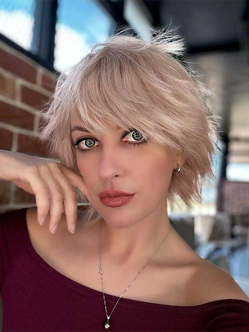 Wispy short shag hairstyle exuding a nostalgic 90's vibe, characterized by soft layers and effortless texture.