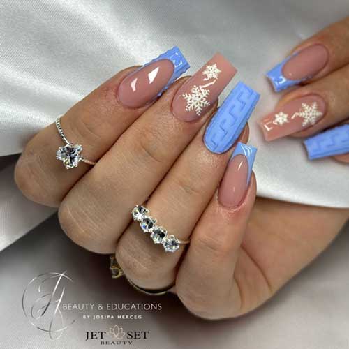 Ice blue sweater nails adorned with intricate sweater art and delicate snowflakes, showcasing a winter-inspired design.