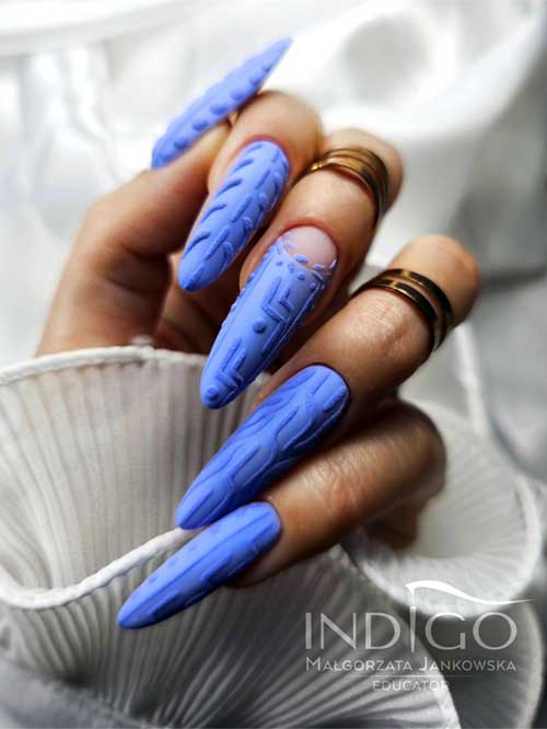 Long light indigo blue sweater nails are displayed elegantly, showcasing its soft texture and stylish design.