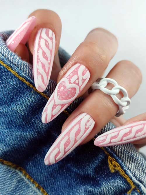 Long light pink nails featuring white sweater nail art and delicate white particles for a stylish winter look.