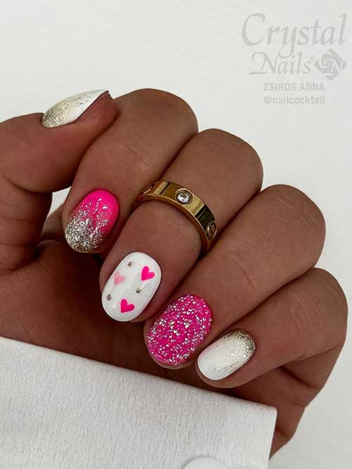 Short Valentine's Day nails with white base, tiny pink hearts, two pink accent nails, and gold glitter accents.