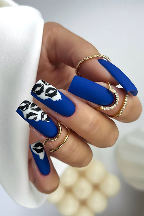 Long square-shaped matte navy blue nails with black lip nail art kisses over a white base color on three accent nails