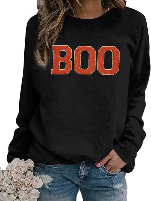 A cozy Boo Halloween sweatshirt featuring BOO letters, perfect for festive autumn celebrations.