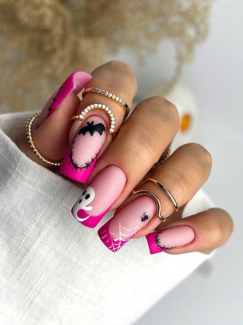 Long square matte hot pink French tip nails featuring Halloween motifs: stitch art, ghost, bat, spider, and web designs.