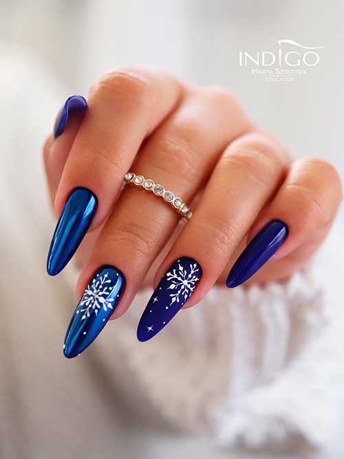Long Navy Blue Christmas gel nails with snowflakes are One of the simplest Christmas nail ideas to wear in 2022