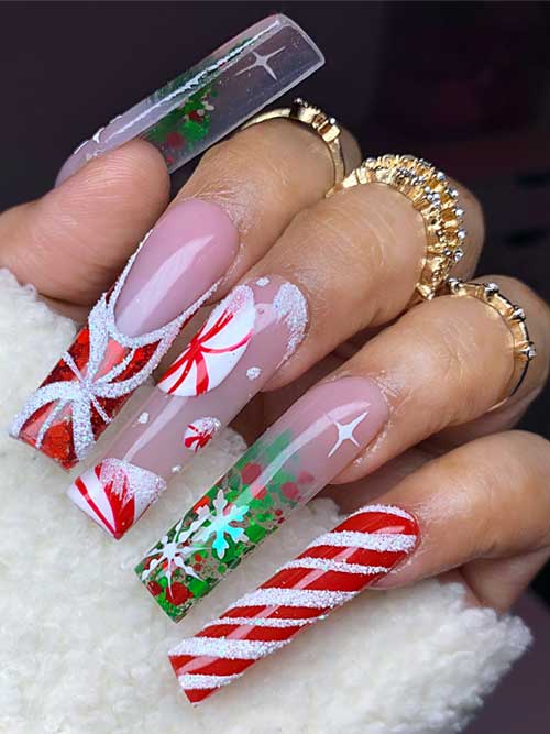 Long square Christmas nails showcasing candy cane accents, snowflakes, and glitter, with a mix of red, green, and nude.