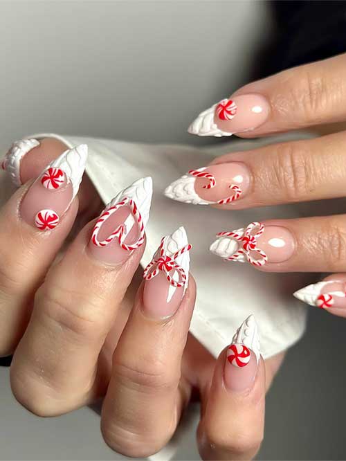 Medium almond-shaped sweater with French white Christmas nails on a nude base color decorated with candy cane nail art.