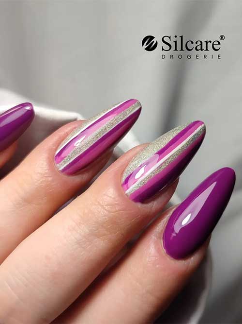 Almond glossy dark purple nails 2023 with stripe nail art on two accent nails