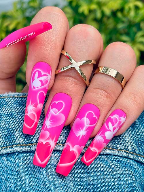 Long coffin-shaped matte ombre Pink Valentine’s Day nails with white hearts