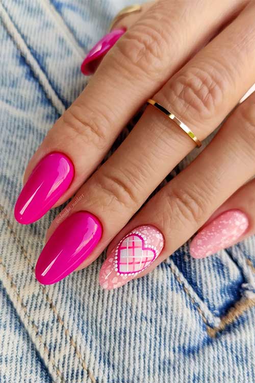 Almond hot pink Barbie nails with nude pink accents adorned with white patches and a heart shape