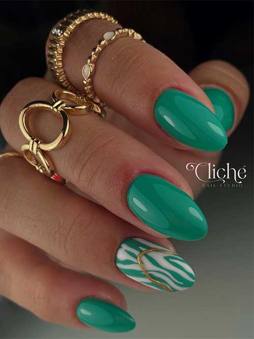 Almond-shaped bold green nails featuring white zebra prints and a 3D gold gel decoration on an accent nail.