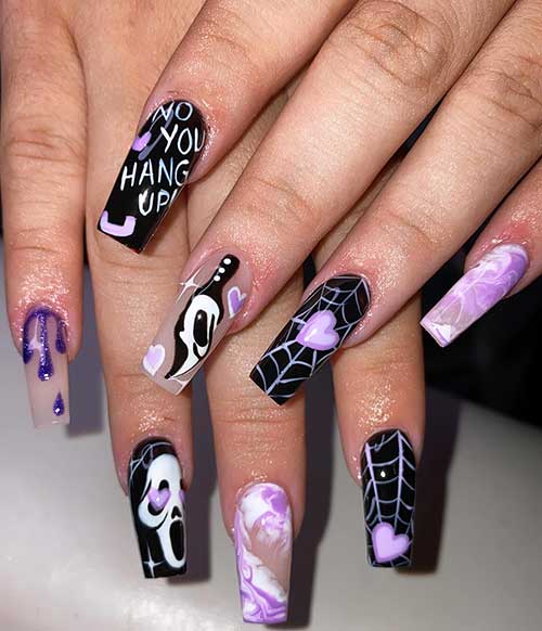 Cute black and purple Halloween nails featuring scary face and cobweb designs for a festive look.