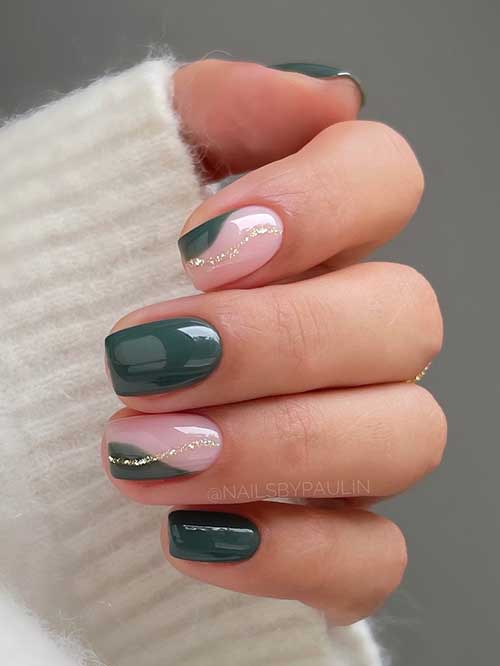 Short dark green nails featuring gold swirls and negative space art on two accent nails, showcasing a stylish design.