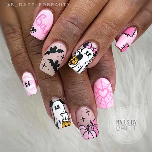 Short pink Halloween nails featuring Mickey and Minnie Mouse ghosts, pumpkins, bats, mummies, and Stitch designs.