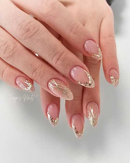 Elegant French nails adorned with medium sequins and shimmering gold glitter are perfect New Year's nail ideas.