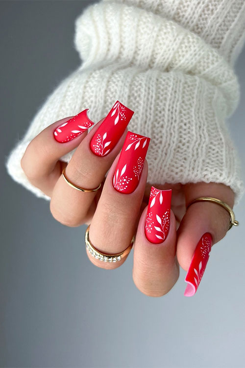 Long square shaped bright red matte nails with white leaf nail art designs