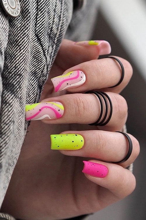 Long square-shaped neon matte hot pink and lime green nails with swirl nail art and black speckles