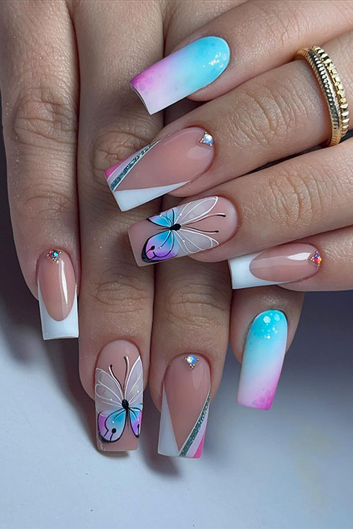 Long square-shaped white French tip nails with an accent ombre nail and a cute butterfly on an accent nude nail