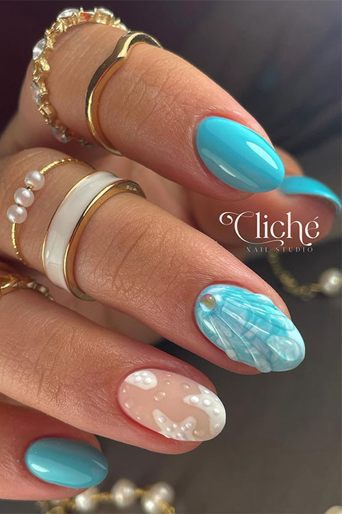 Short almond-shaped sky blue pretty summer nails with water droplets nail art forming a mermaid nail art adorned with a pearl