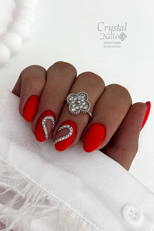 Short matte red summer nails with silver rhinestones forming a heart shape divided into two accent nails