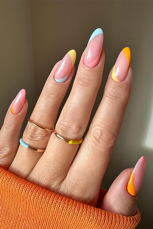 Soft colorful diagonal and reverse diagonal French tip nails over nude almond-shaped nails