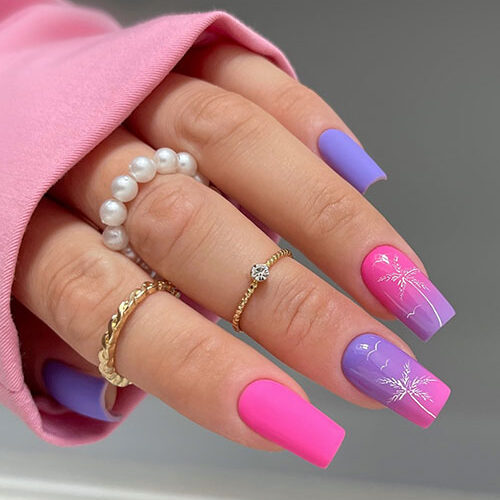 Matte purple and pink summer nails inspo with two accent glossy ombre pink and purple nails adorned with white palm trees