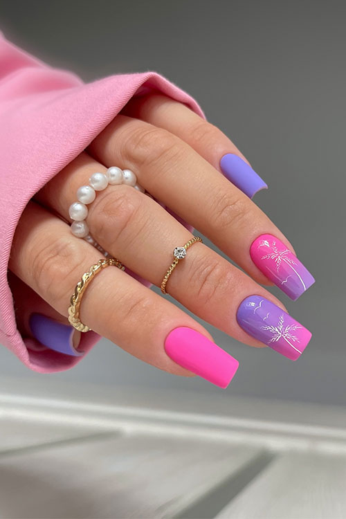 Matte purple and pink summer nails inspo with two accent glossy ombre pink and purple nails adorned with white palm trees