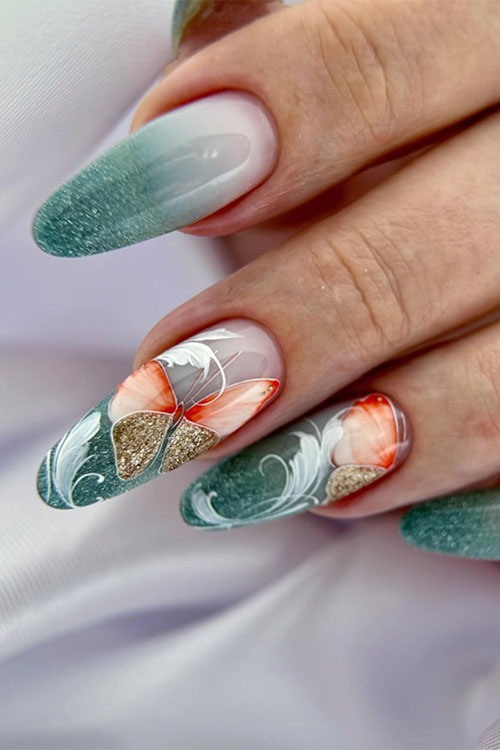 Milky white and green ombre nails adorned with glitter and decorated with orange and gold glitter butterflies