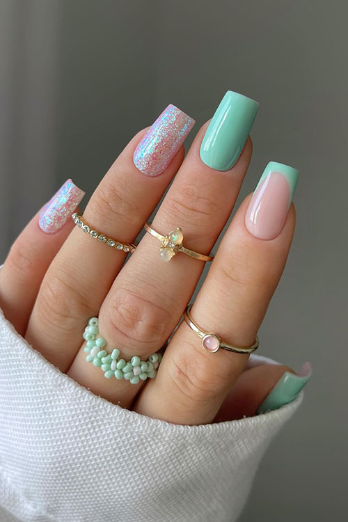 Summer nails inspo mint features simple mint green square-shaped nails and two nude accent nails adorned with holo glitter