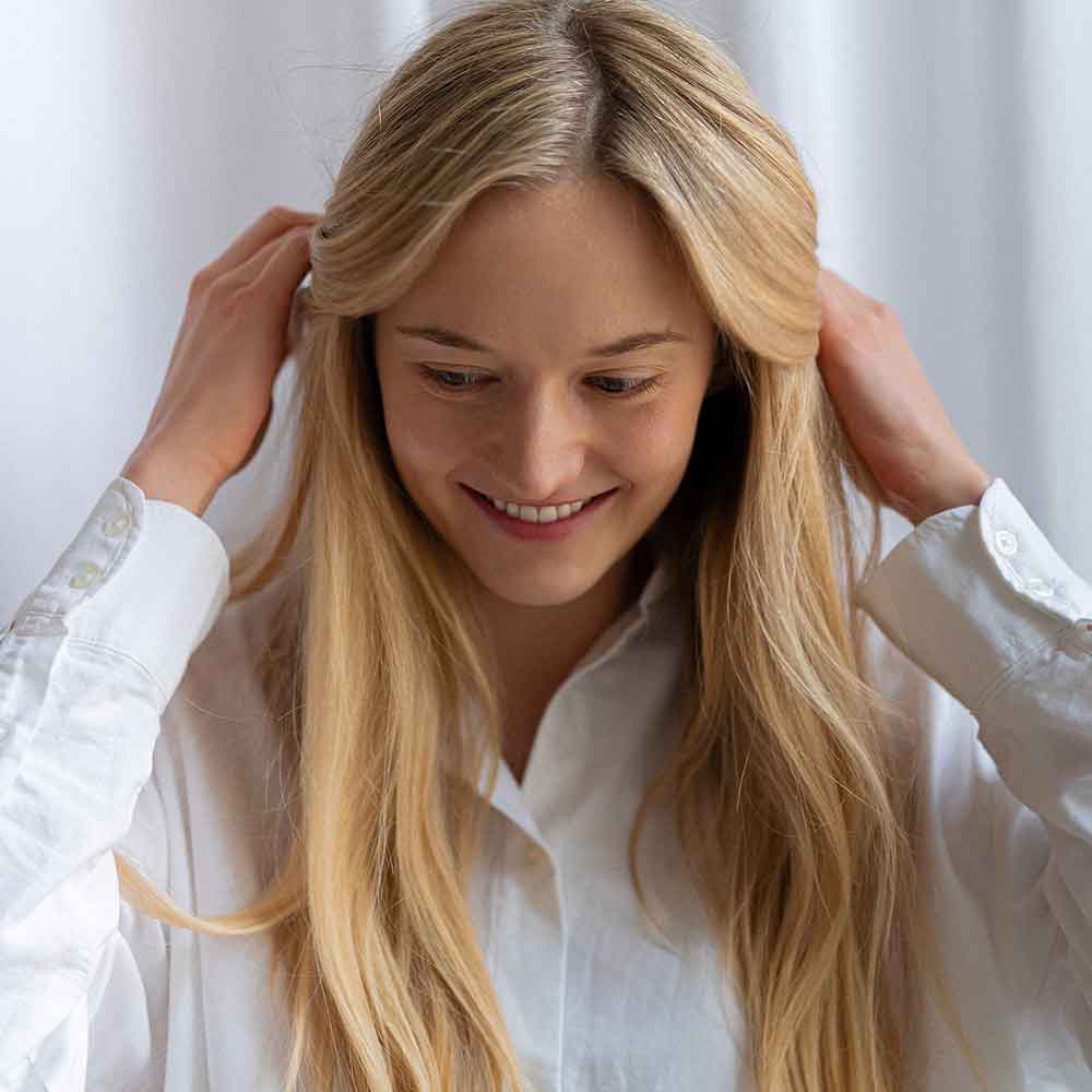 A girl with long, moisturized hair showcases essential tips for moisturizing natural hair effectively.