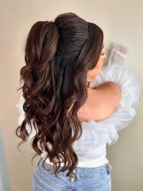 A hairstyle featuring half of the hair twisted up while the remaining hair flows down, creating an elegant look.