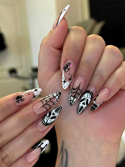 Black and white French Halloween nails adorned with various Halloween motifs, showcasing a festive and stylish design.