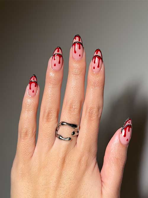 Creepy French Halloween nails featuring negative space and blood drip art for a hauntingly stylish look.