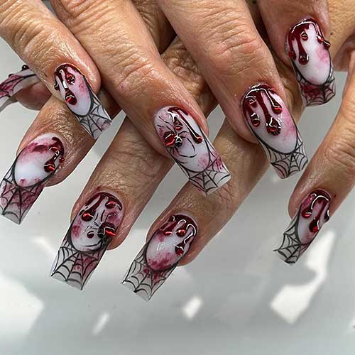 Creepy milky white Halloween French nails with red gel drip, blood splatter art, and black spider web tips.