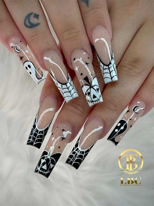 Cute black and white two color hand nails with spider webs, ghosts, and a stitched pumpkin face