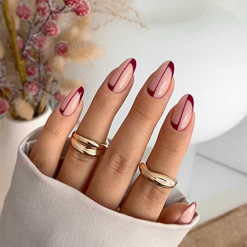 Elegant burgundy fall nails showcase half French and reverse French designs with a stylish center line accent.