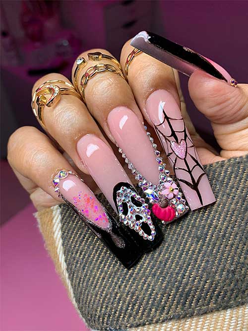 Elegant nude pink nails with black French tips, silver rhinestones, a scream face accent, and a spider web design.